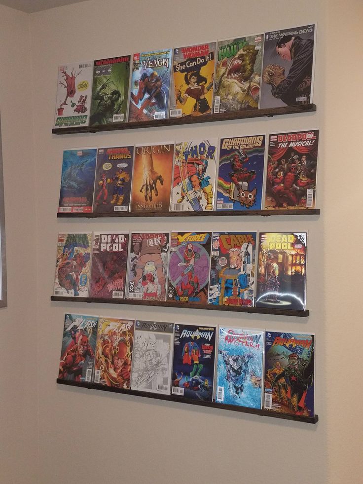 several comics are hanging on the wall above a toilet