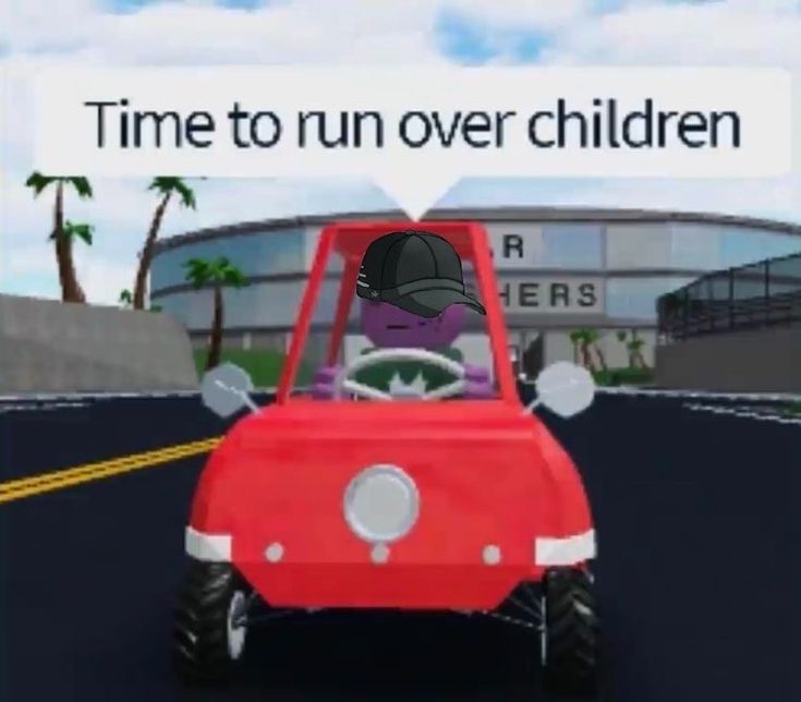 a red car driving down a street next to a tall white sign that says time to run over children