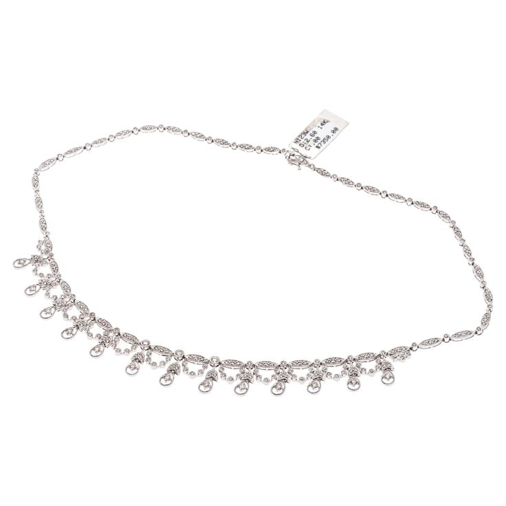 14k white gold necklace. This gorgeous necklace contains alternating oval and round links, milgrain edged and set with round faceted diamonds. The center of the necklace is decorated with tulip topped pear shaped links, alternating with festooned round links, all set with round faceted diamonds. The entire diamond weight for the necklace is 2.60 TCW, and the clasp is a hidden box style with double figure eight safeties. Marks: 14k Dimensions: 16 1/4" long; center is 17/32" long Weight: 12.8 gros White Gold Necklace, Fringe Necklace, White Gold Necklaces, Lorde, Gorgeous Necklaces, Link Necklace, White Gold Diamonds, Pear Shaped, Chains Necklace