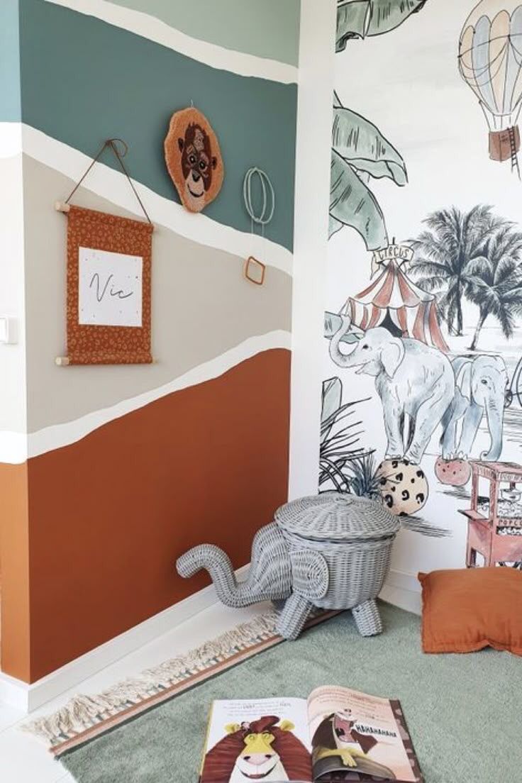 a child's room with an elephant wall mural