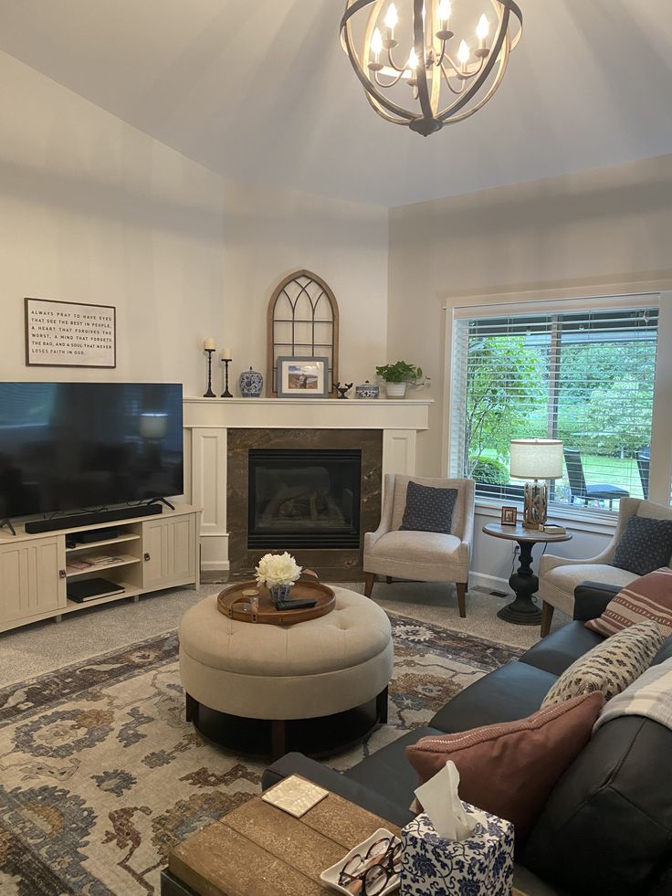 a living room filled with furniture and a flat screen tv on top of a fireplace