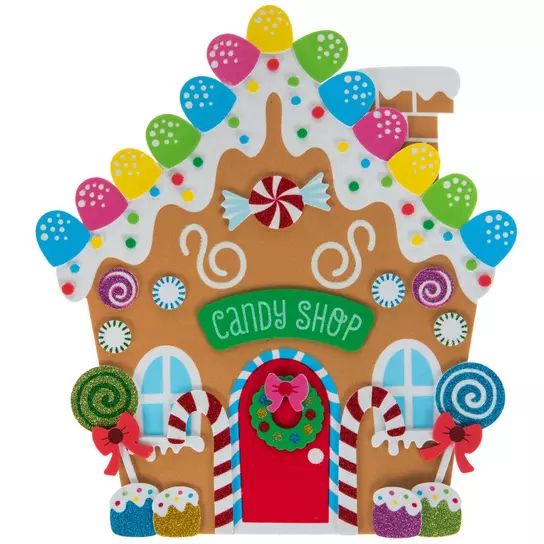 a gingerbread house with candy and candies on the front, decorated in bright colors