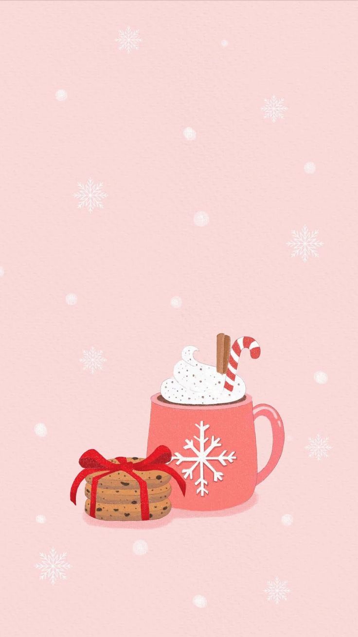 a pink mug filled with hot chocolate and marshmallows next to a cookie