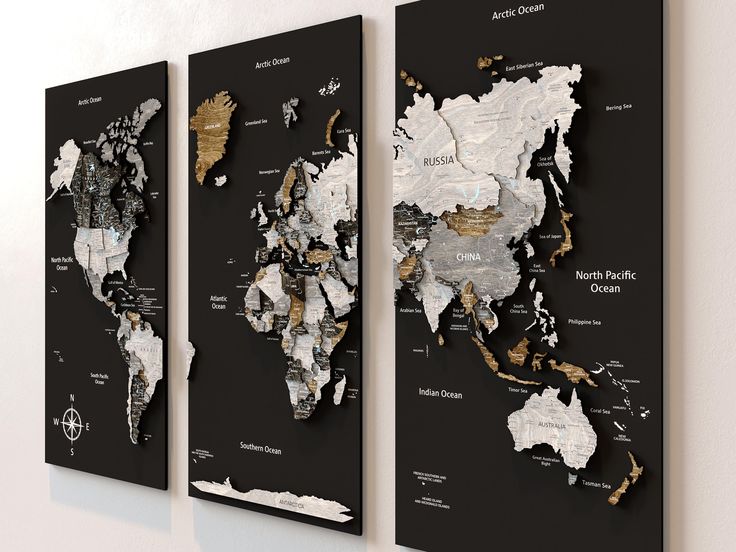 three black and white maps hanging on the wall with gold foil accents, each showing different countries