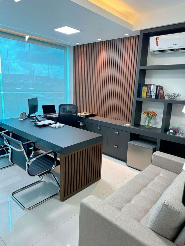 an office with modern furniture and large windows