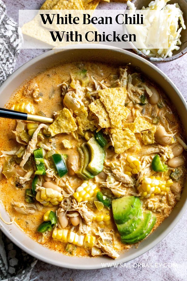 a bowl of white bean chili with chicken and tortilla chips on the side