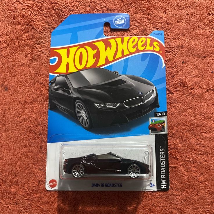 a hot wheels car is shown on the carpet in this photo, it appears to be black