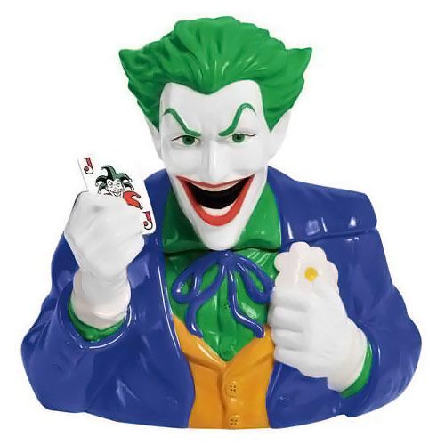 a statue of the joker holding a toy in one hand and an object in the other