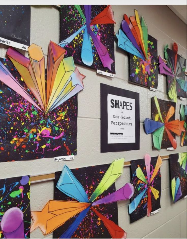 colorful art pieces are displayed on the wall in this classroom setting with information about shapes