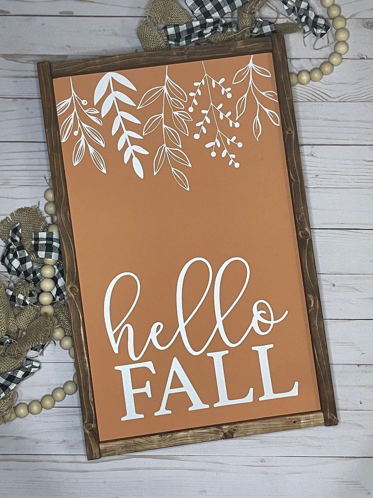 a wooden sign that says hello fall on it