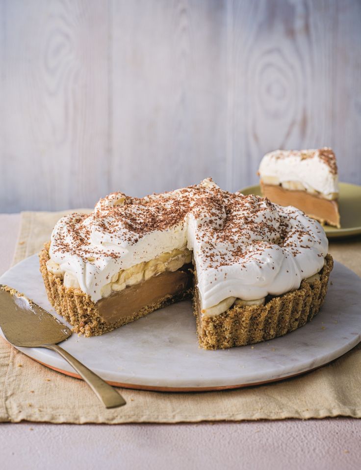 a piece of pie on a plate with a fork next to it and another slice in the background