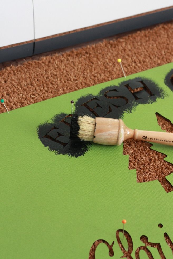 a paintbrush sitting on top of a green sign