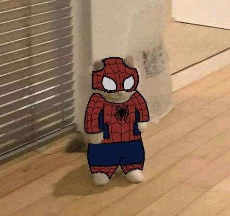 a spiderman stuffed animal sitting on top of a hard wood floor