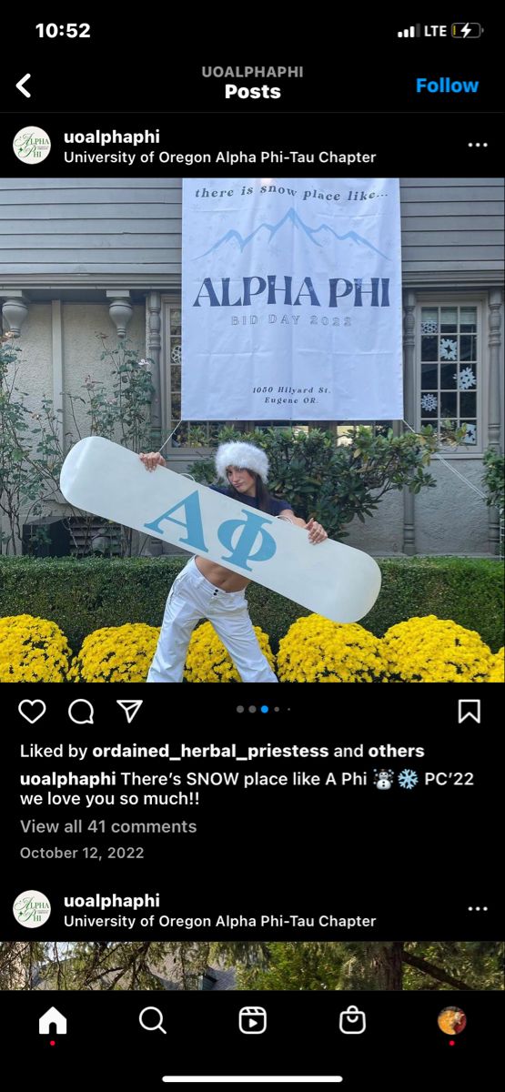 a person holding a snowboard in front of a building