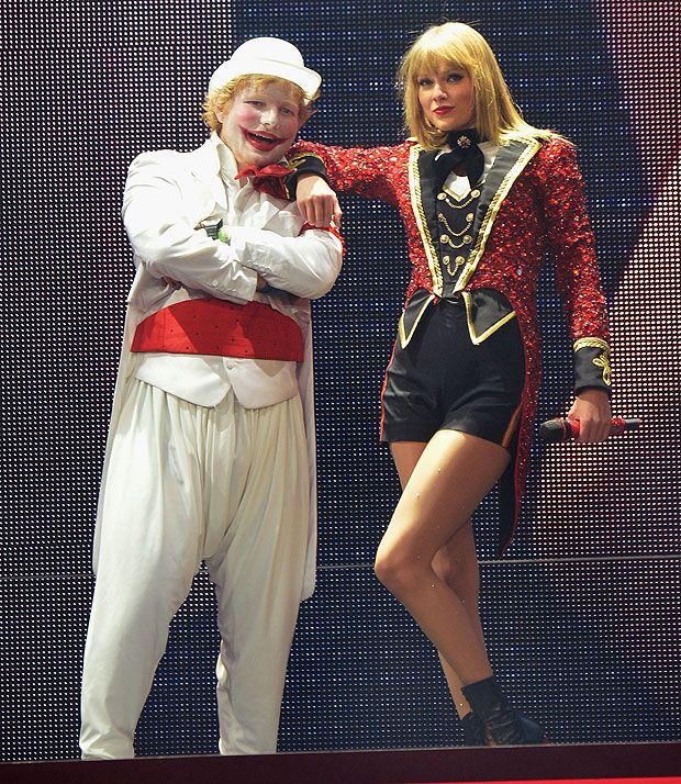 two people dressed as circus performers posing for the camera