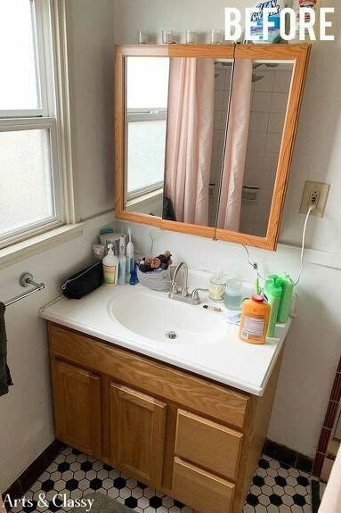 a bathroom sink sitting under a mirror next to a window