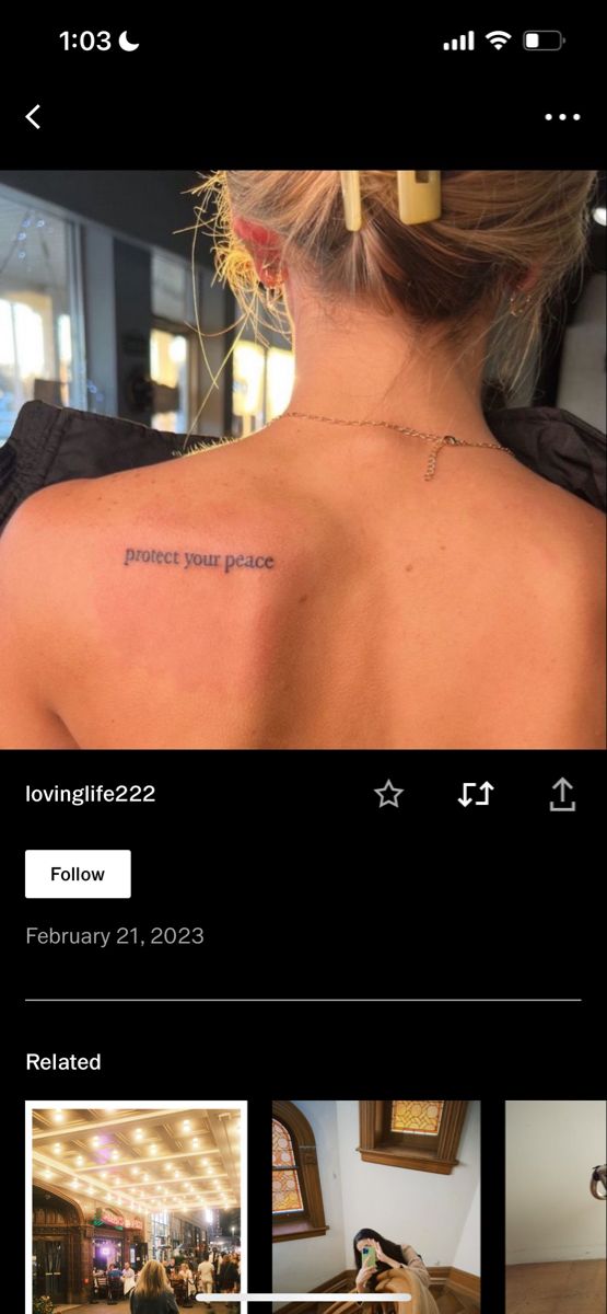 the back of a woman's neck with an inscription on her left shoulder and two images