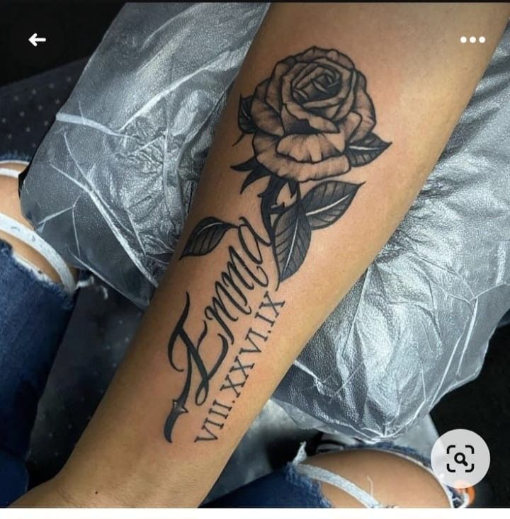 a woman's arm with a rose and the words family written in cursive writing