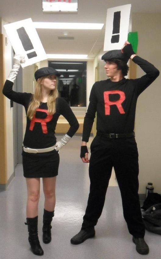 two people dressed up in costumes with signs on their heads