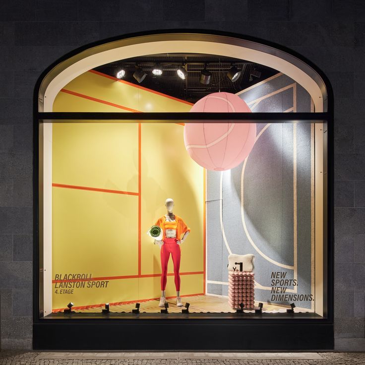 a window display with mannequins and balloons