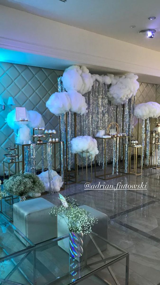 a room filled with tables and chairs covered in white fluffy clouds