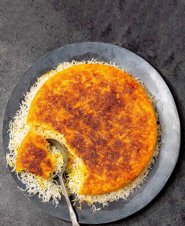 an omelet on a plate with a serving spoon