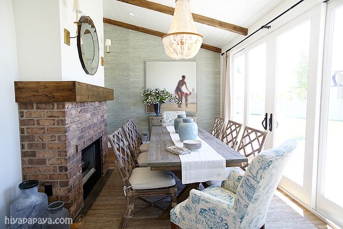 a dining room table with chairs and a fire place