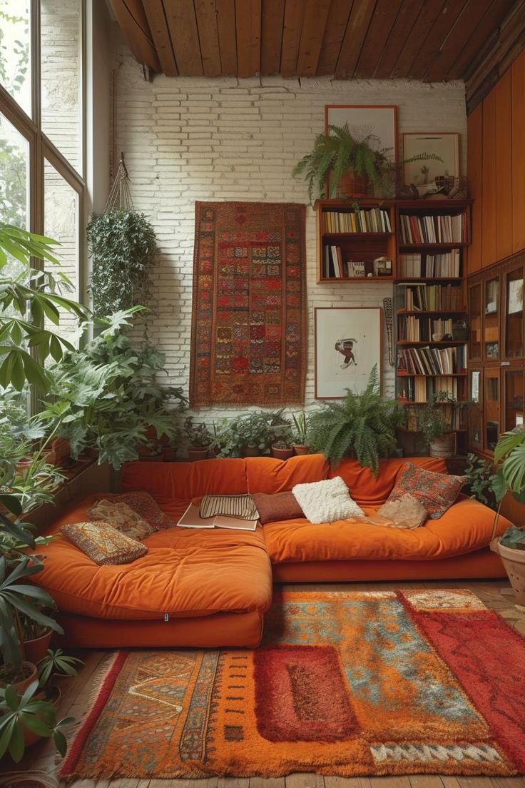 a living room with an orange couch and rugs