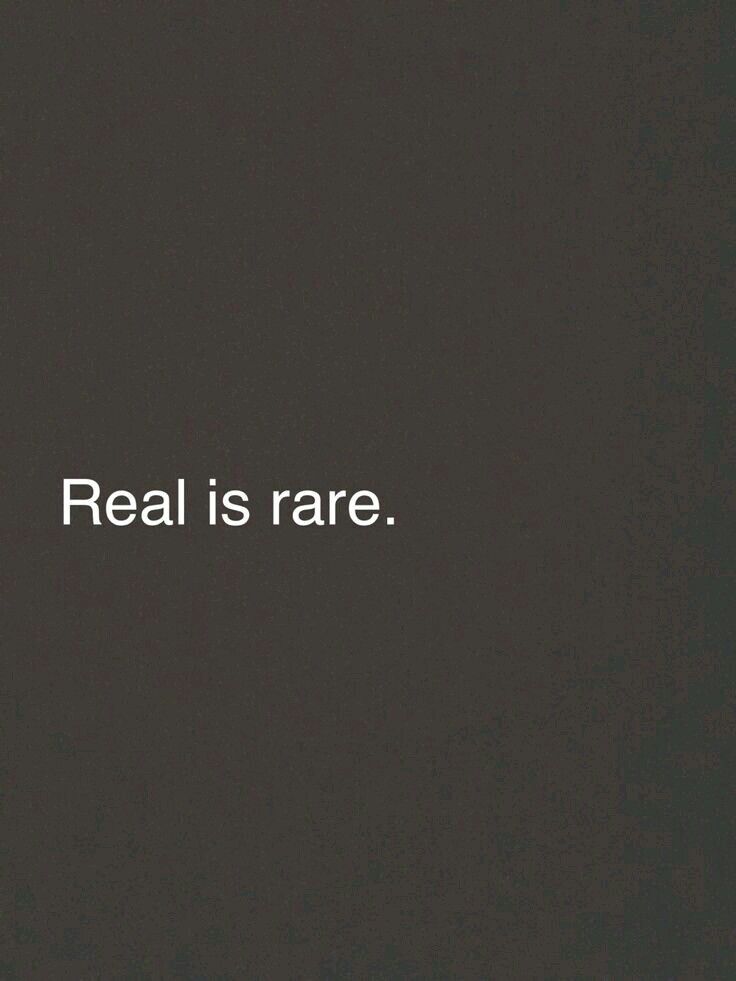 the words real is rare on a black background