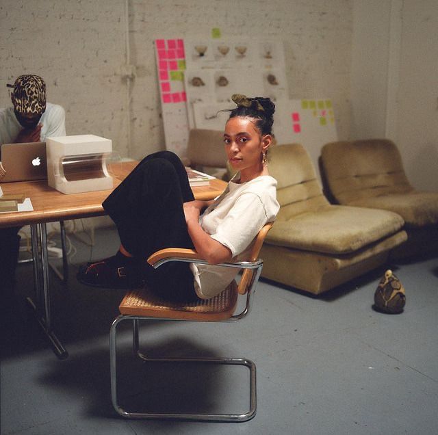 a woman sitting on a chair in an office