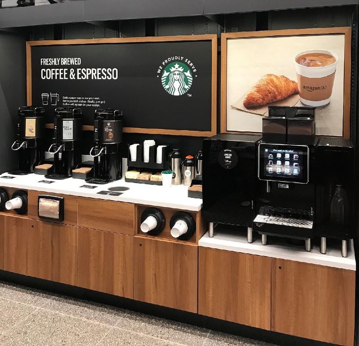 there is a counter with coffee and espresso machines on display in the store