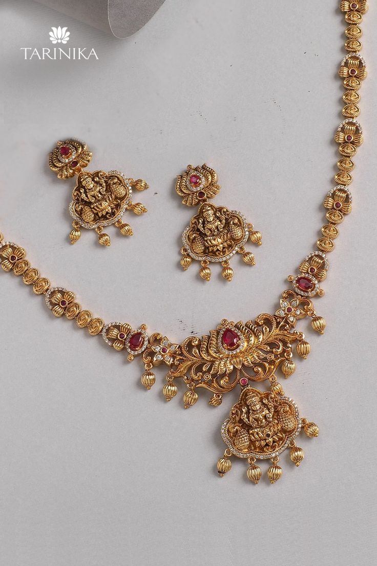 Make a statement with timeless temple jewelry from the house of Tarinika. Avail 10% off upon using code NEW10. Gold Bridal Sets With Stone Work For Celebration, Festive Bollywood Gold Temple Necklace, Gold Kundan Bridal Necklace For Navratri, Temple Jewelry Bridal Sets For Diwali, Gold Bridal Necklace With Stone Work For Festive Occasions, Festive Gold-plated Temple Necklace With Stone Work, Bollywood Style Intricate Design Sets For Puja, Gold Temple Jewelry Sets For Wedding, Gold Kundan Jewelry Set For Navratri