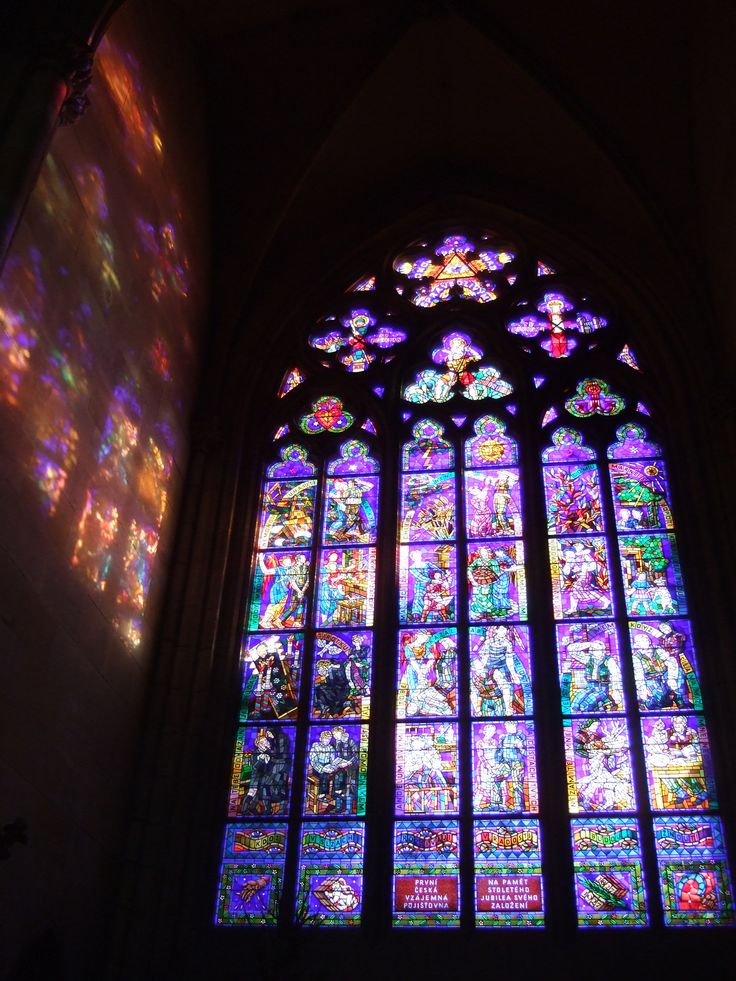 a large stained glass window in a church