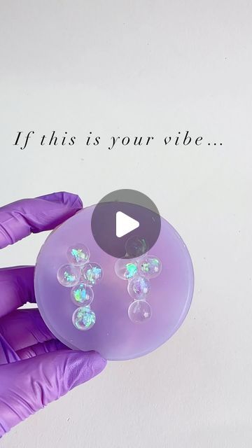 a purple gloved hand holding an object that says, if this is your vibe