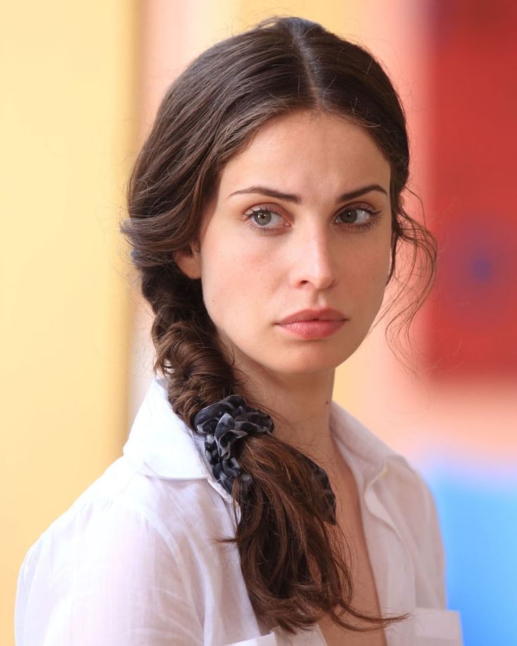 a woman with long hair wearing a white shirt