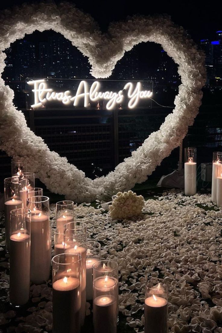 candles are arranged in front of a heart shaped sign