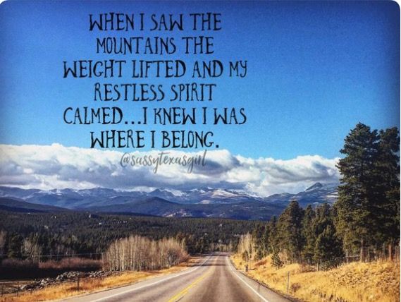 an empty road with the words when i saw the mountains the weight lifted and my restless spirit came, i knew i was where i belong