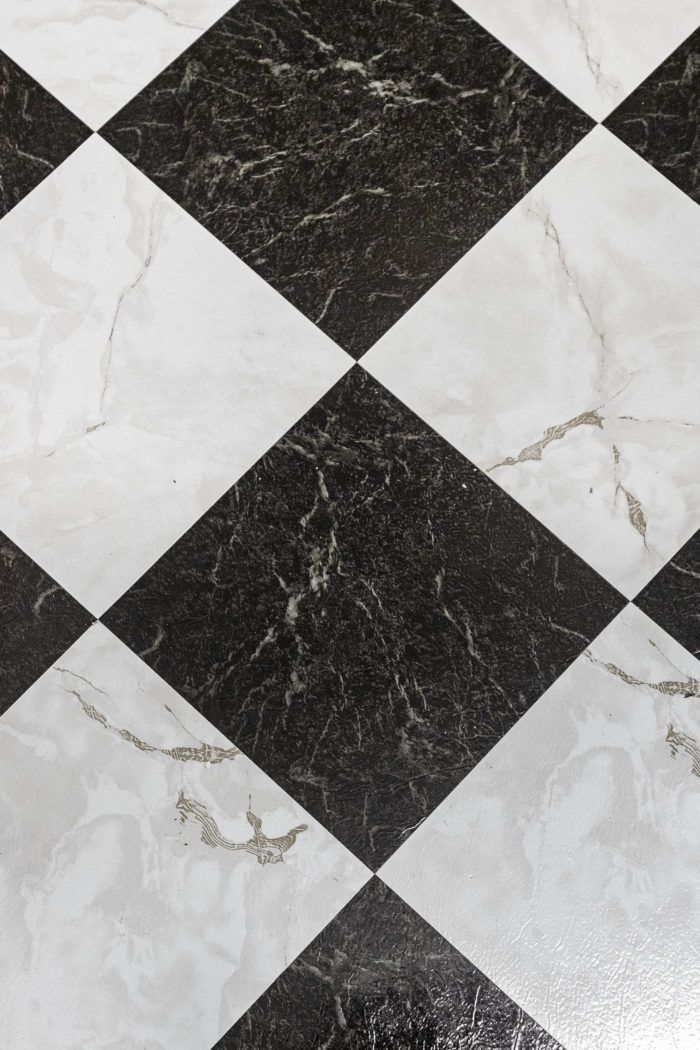 a black and white checkered floor with marble