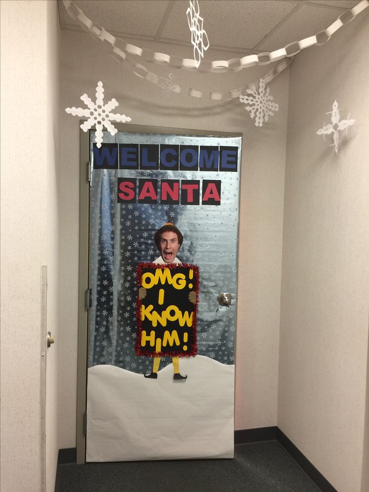 a door decorated with an image of santa holding a sign