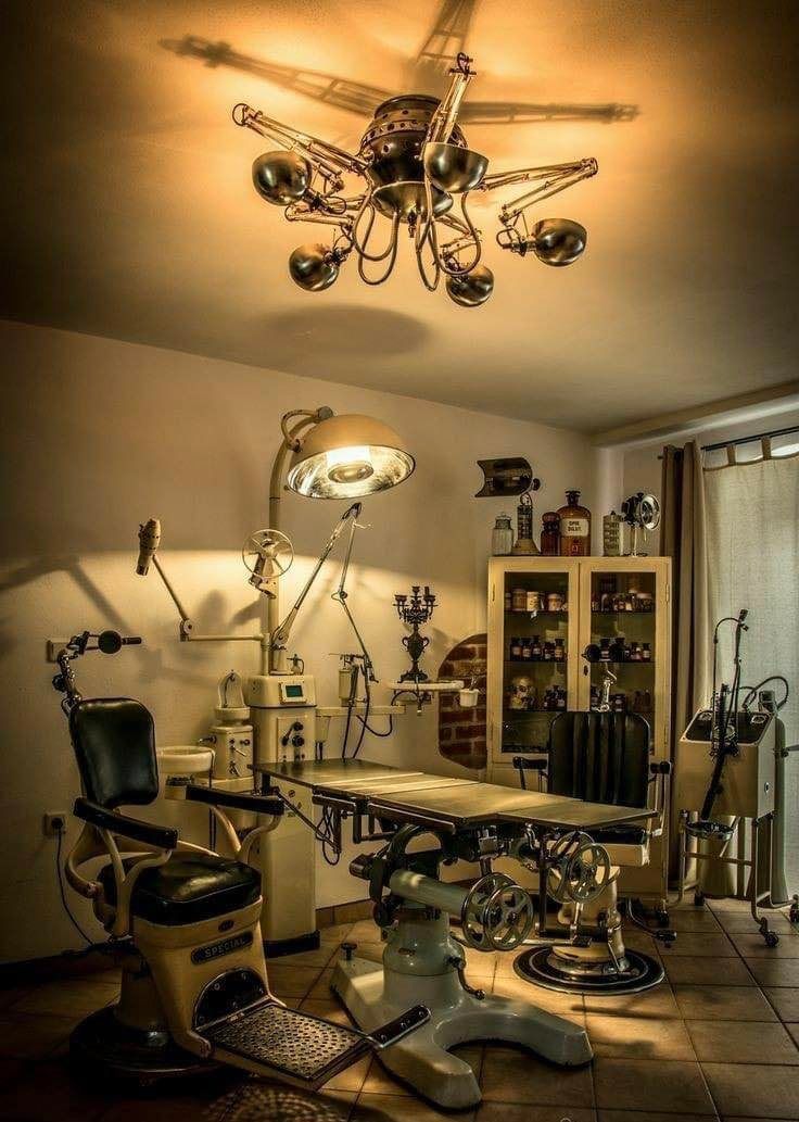 an old fashioned dentist's office with lots of medical equipment on the floor and in front of a window