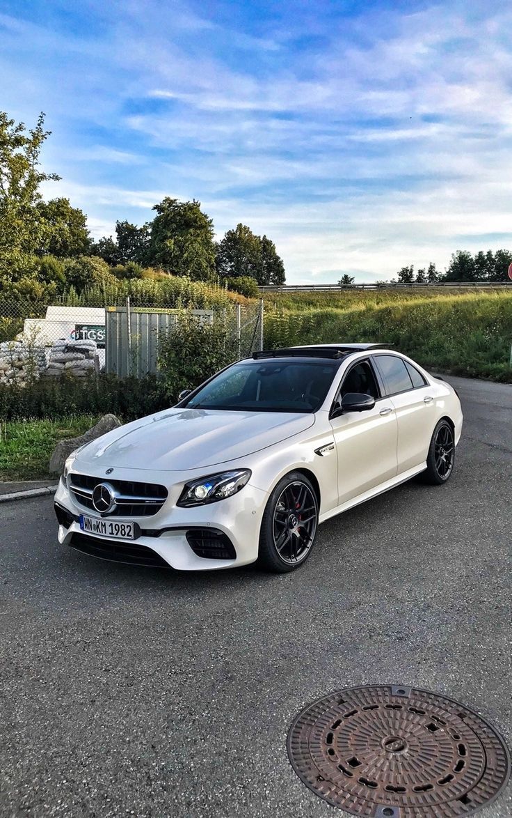 a white car is parked on the street