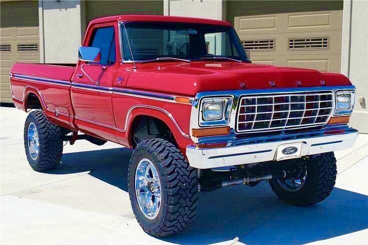 a red truck parked in front of a garage