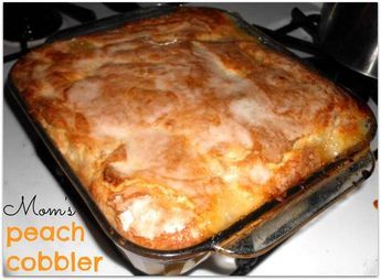 a casserole dish sitting on top of a stove with the words mom's peach cobbler written above it