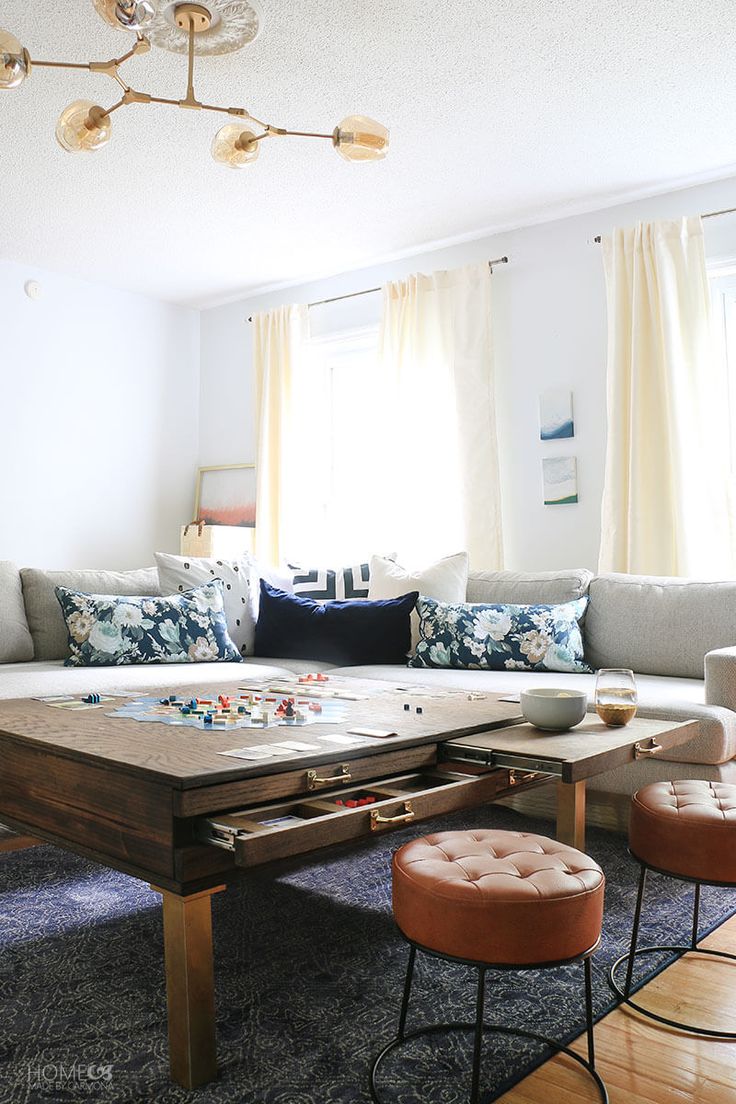 a living room filled with furniture and lots of pillows on top of it's couches