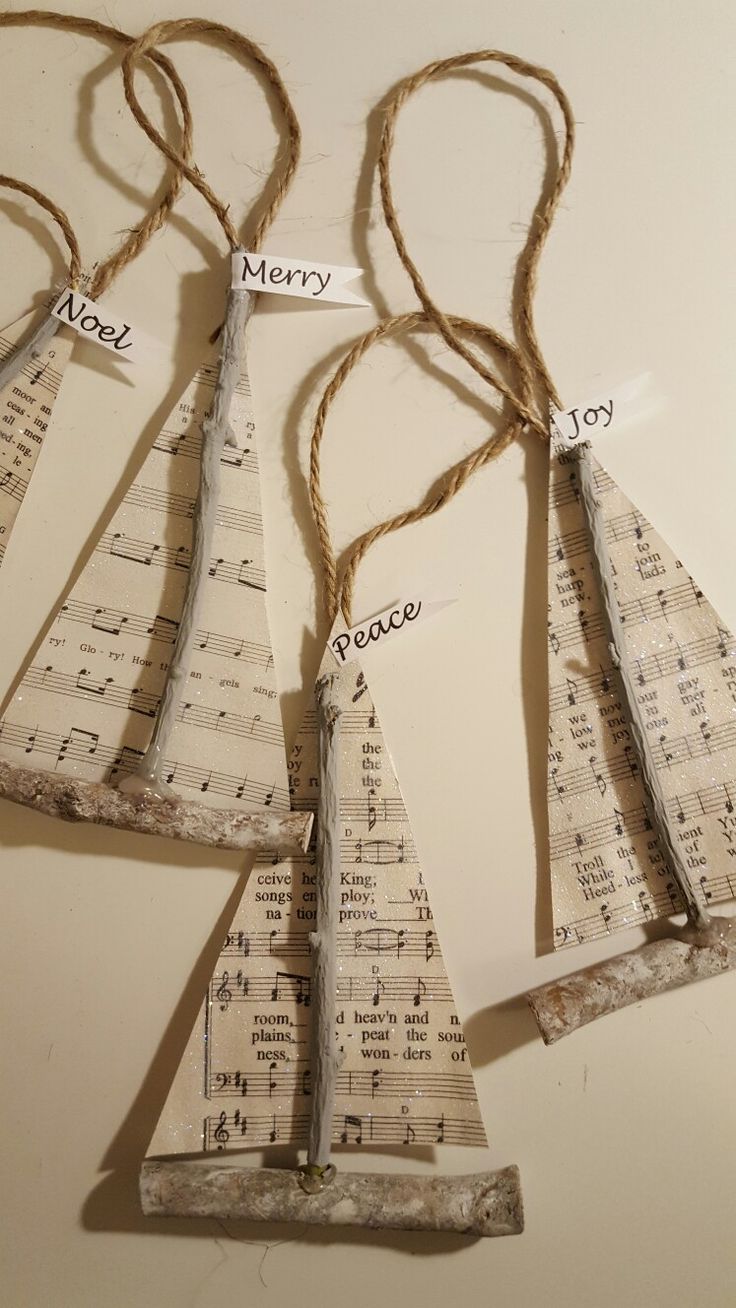 four pieces of music paper are hanging from twine