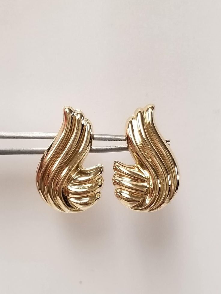 "Thanks for shopping our vintage estate store. We tend to sell well below wholesale and truly hope you enjoy all of our items. Many of the items are one of a kind, so please enjoy scrolling through the pictures and hopefully something will catch your eye. Brown spots are from camera or reflections. Nice estate new 14k yellow gold wave earrings. Length: 1\" Width: 3/4\" Weight: 3.20 grams Earrings are marked 14k." Vintage Yellow Gold Earrings For Anniversary, Classic Polished Finish Clip-on Earrings For Anniversary, Classic Polished Clip-on Earrings For Anniversary, Retro Yellow Gold Formal Earrings, Vintage 14k Gold Earrings With Polished Finish, Vintage Clip-on Earrings With Polished Finish For Anniversary, Vintage Style Clip-on Earrings With Polished Finish For Anniversary, Retro Gold Jewelry Stamped 14k, Vintage Yellow Gold Hoop Earrings For Formal Occasions