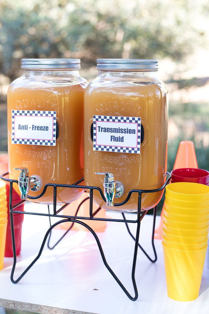 two jars filled with liquid sitting on top of a table