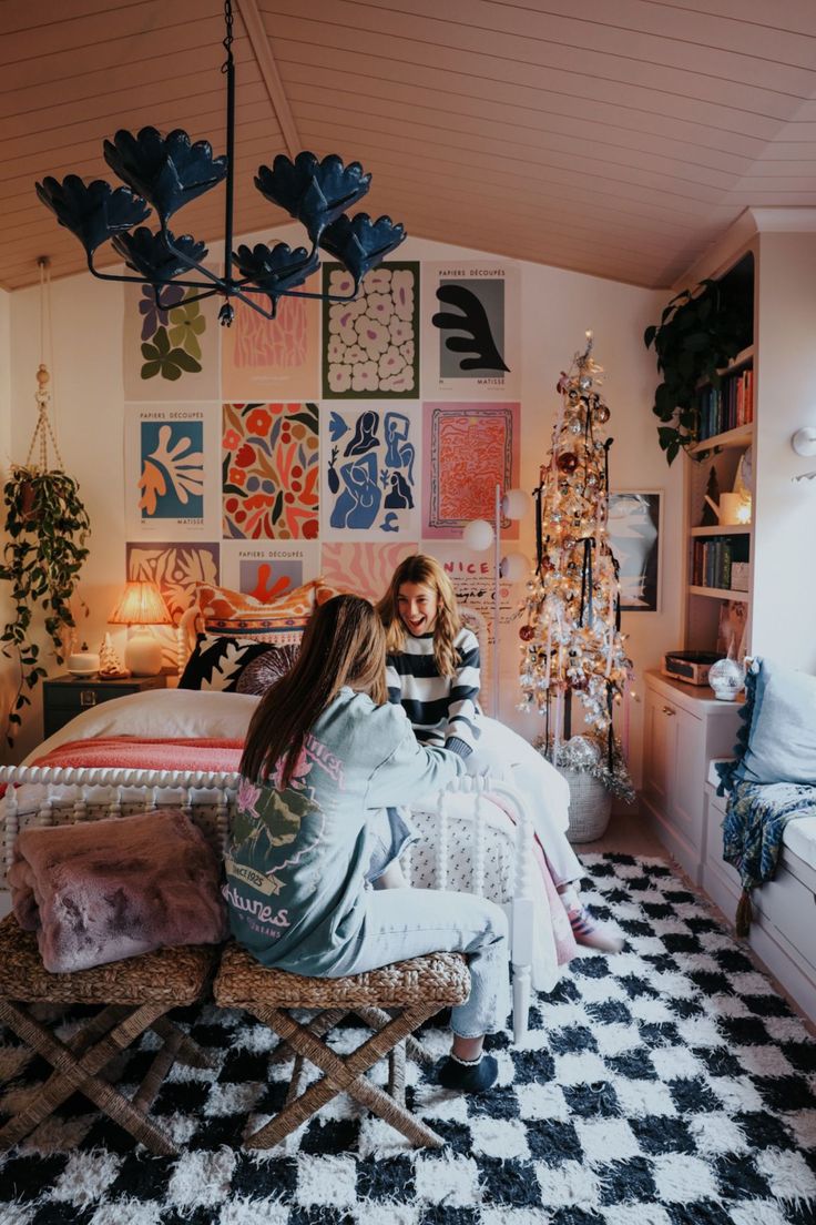 a woman sitting on top of a bed next to a black and white checkered floor