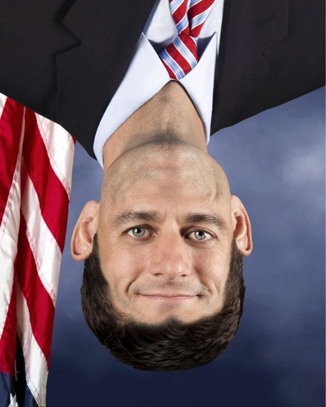 a man in a suit and tie upside down with an american flag on his head