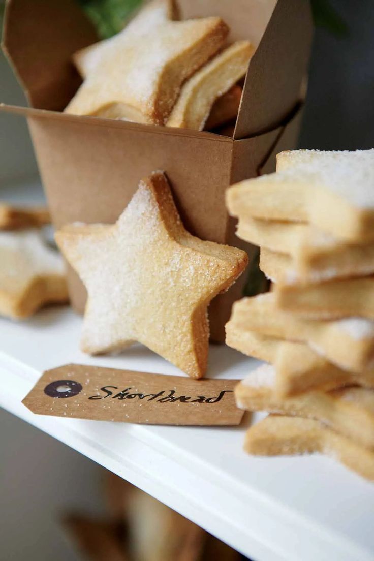 some cookies are sitting on a table with a star shaped cookie in front of them